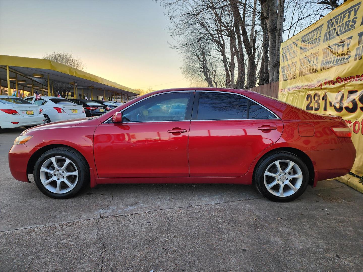 2009 Red /Gray Toyota Camry CE 5-Spd AT (4T4BE46K79R) with an 2.4L L4 DOHC 16V engine, Automatic 5-Speed transmission, located at 16710 Clay Rd., Houston, TX, 77084, (281) 859-7900, 29.834864, -95.656166 - Photo#4