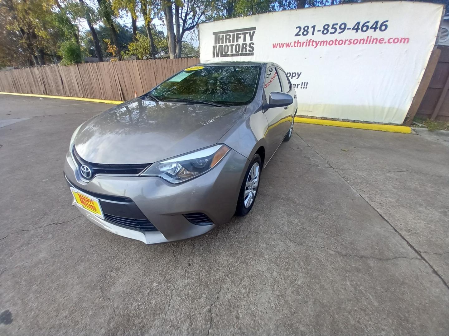 2016 BLACK Toyota Corolla L 4-Speed AT (5YFBURHE2GP) with an 1.8L L4 DOHC 16V engine, 4A transmission, located at 16710 Clay Rd., Houston, TX, 77084, (281) 859-7900, 29.834864, -95.656166 - Low Down. Low Payments. - Photo#2