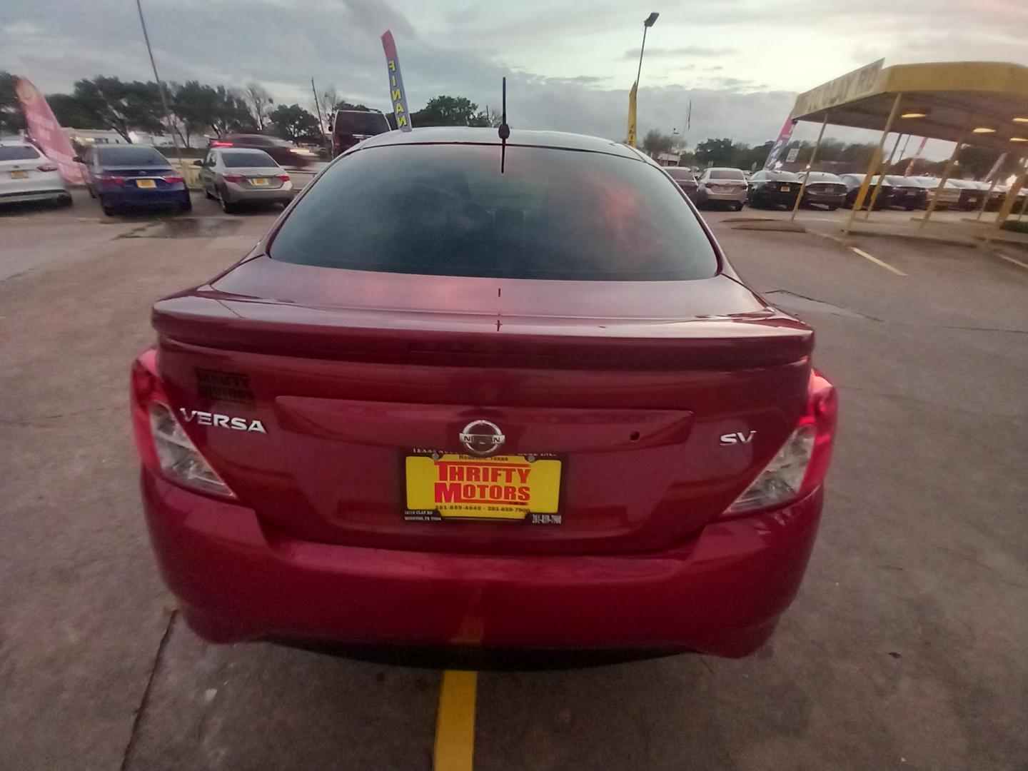 2019 Red Nissan Versa 1.6 SV Sedan (3N1CN7AP5KL) with an 1.6L L4 DOHC 16V engine, CVT transmission, located at 16710 Clay Rd., Houston, TX, 77084, (281) 859-7900, 29.834864, -95.656166 - Low Down. Low Payments. - Photo#4